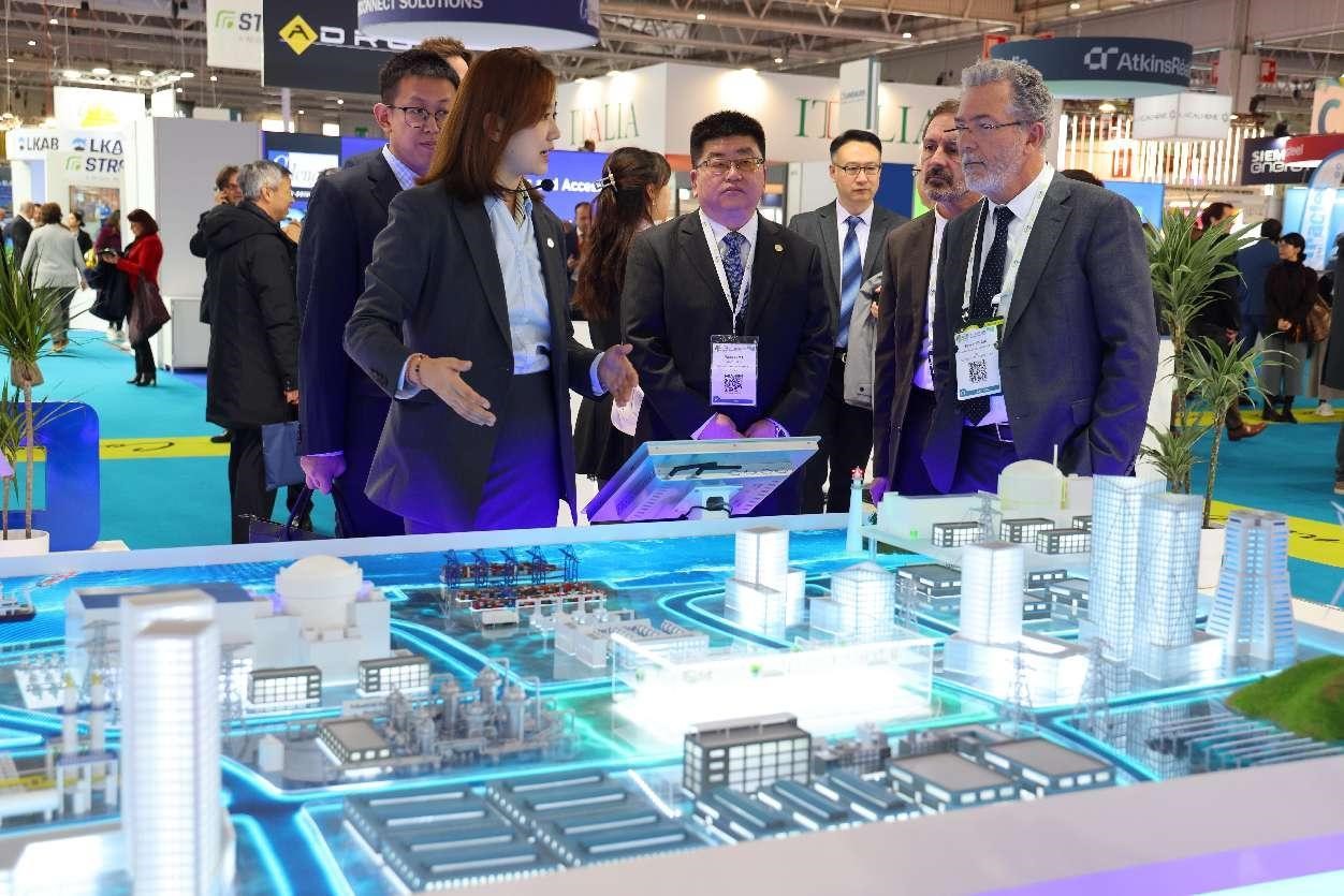 Un employé de la China National Nuclear Corporation présente l'exposition de la société au directeur de la Commission fran?aise des énergies alternatives et de l'énergie atomique lors de la 5e Exposition nucléaire mondiale qui s'est tenue à Paris en novembre 2023. (Shang Kaiyuan / Le Quotidien du Peuple)