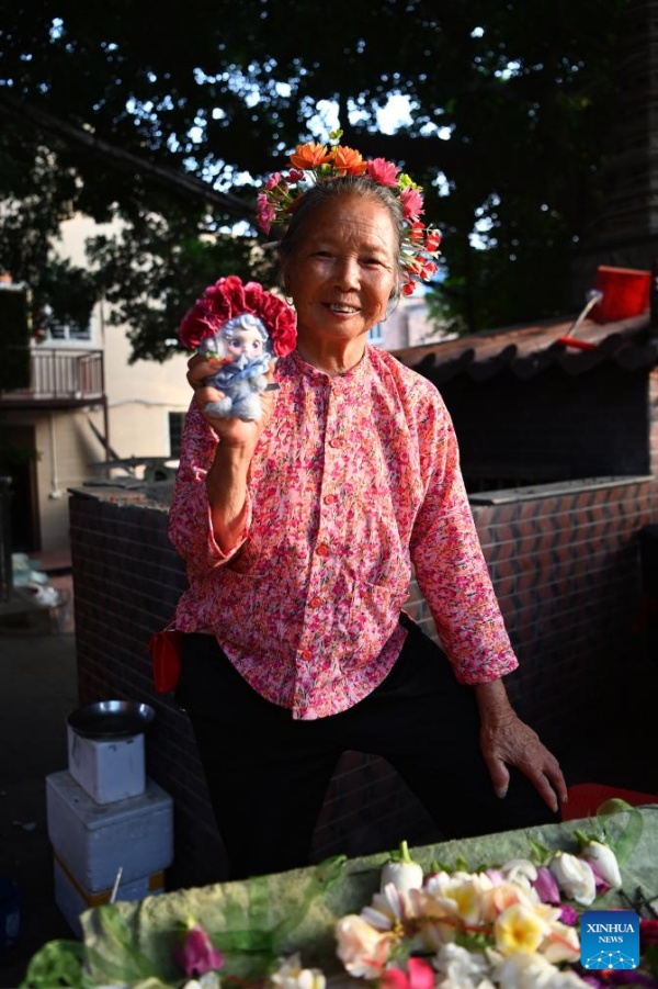 Fujian?: les couvre-chefs fleuris traditionnels stimulent l'essor touristique du village de Xunpu