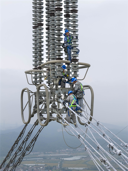 Anhui : des ouvriers électriciens appliquent de la peinture antigel à haute altitude à Tongyang